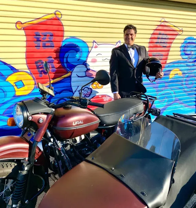 Daniel with the sidecar beside a Melbourne mural